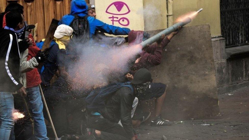 About seven protesters wearing hoods attempting to fire a homemade mortar during the clashes with police