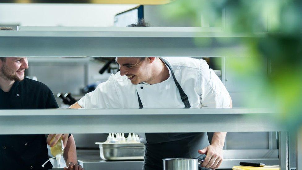 Andrew Sheridan and staff member working in the kitchen at Sosban in Llanelli