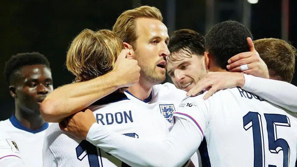 England players celebrate a goal.