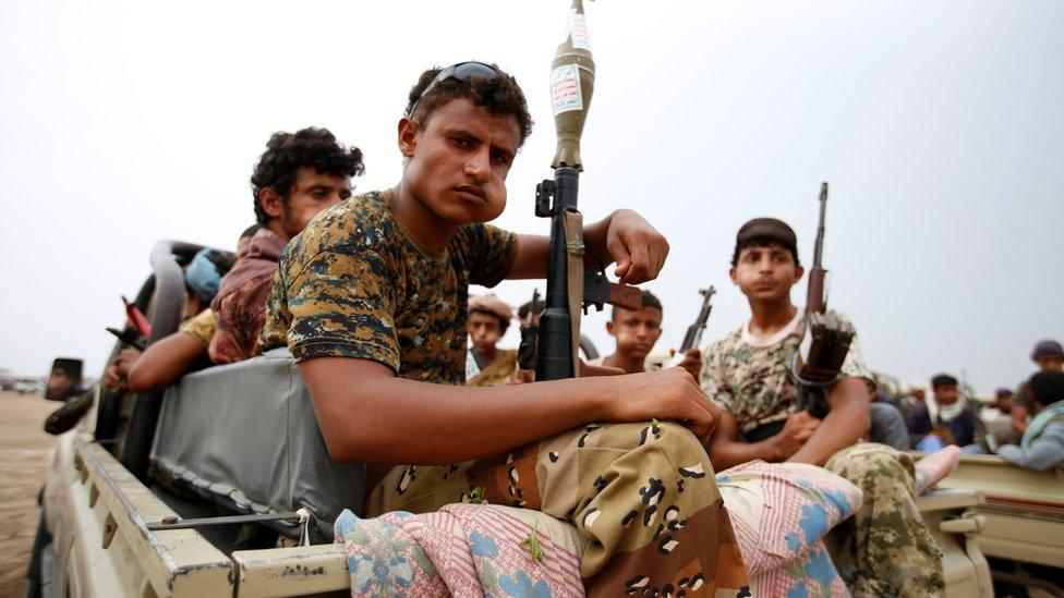 Houthi fighters ride on the back of a pick-up truck during a parade in the Red Sea port city of Hudaydah, Yemen (24 August 2017)