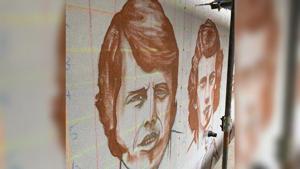 A close-up of two of the portraits in an unfinished state.