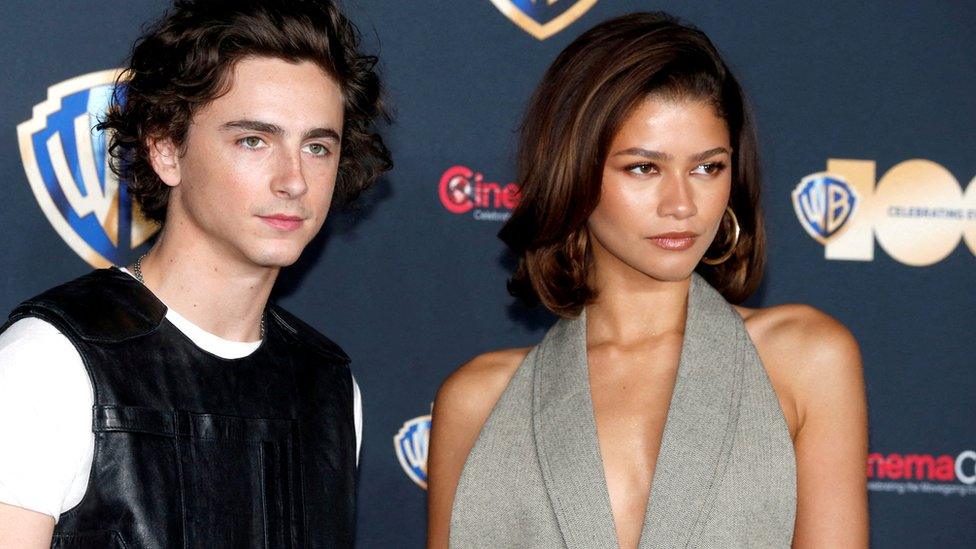 Actors Timothee Chalamet and Zendaya posing for photos