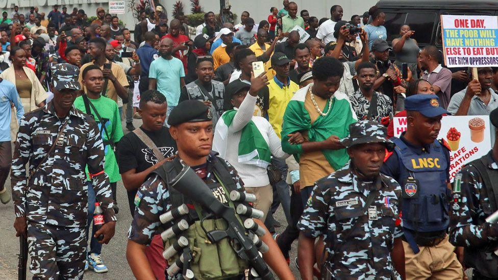 Members of security forces escort demonstrators during a rally against the cost-of-living crisis the country is experiencing, in Lagos, Nigeria - 1 August 202