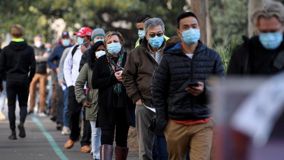 People in Sydney queuing for vaccines during the city's lockdown