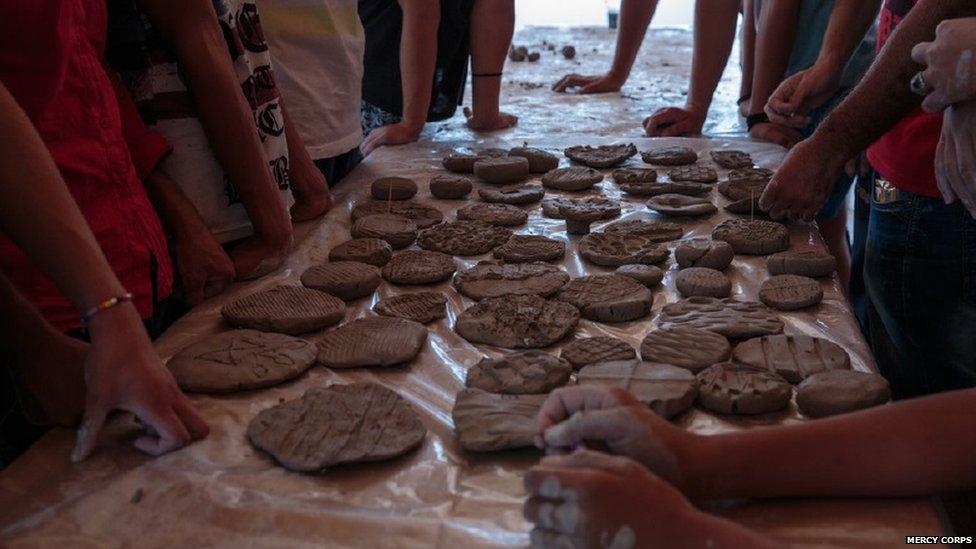 Hands making pottery