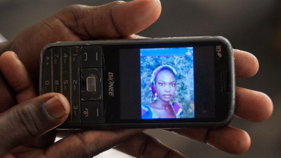 The mother of Rifkatu Galang, one of the abducted Chibok girls, holds a phone showing her photo - April 2016