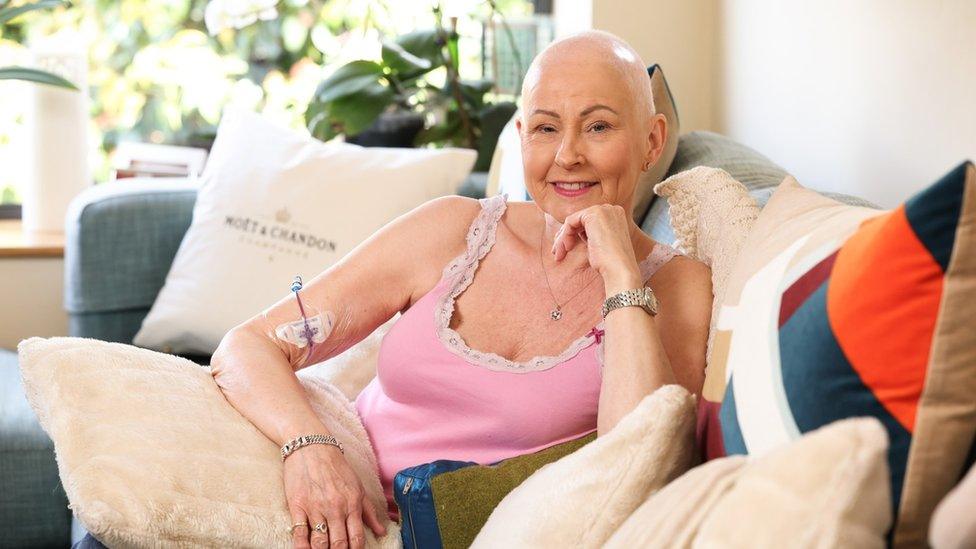 Pamela Ballentine sat on a sofa not wearing her wig