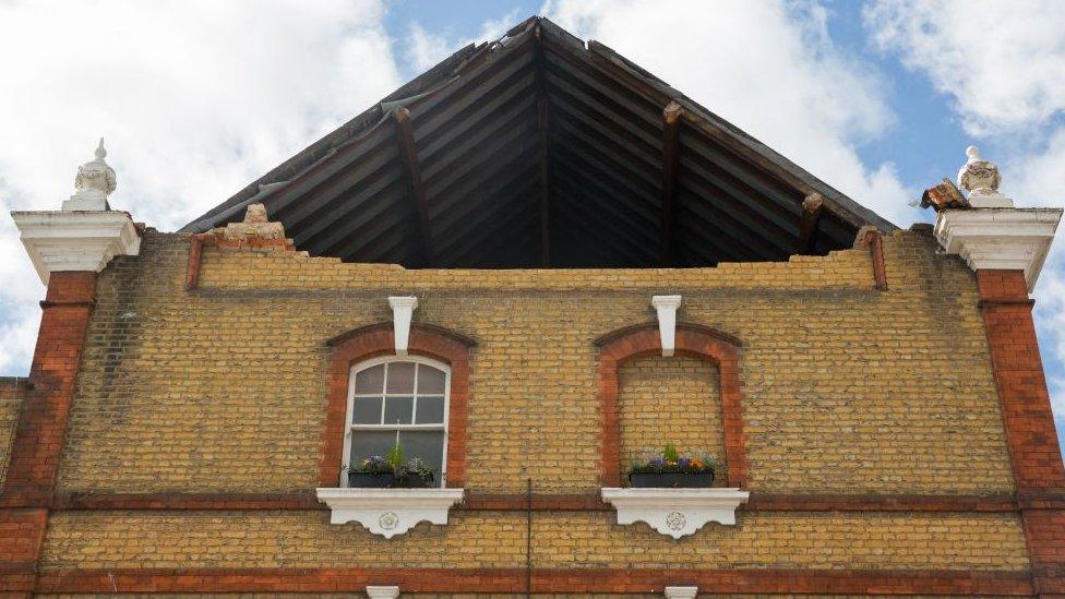 A picture shows the hole in the roof support of a pub.