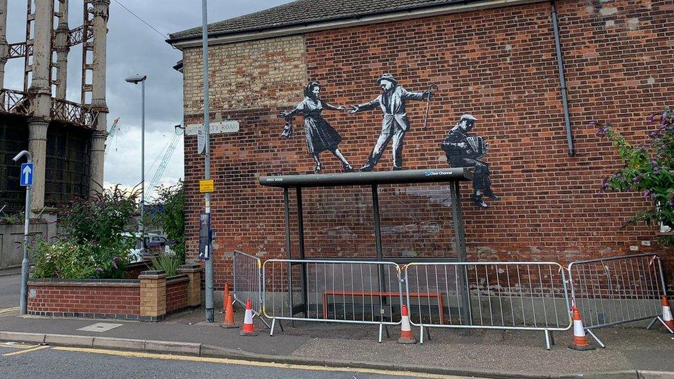 Banksy mural with barriers installed