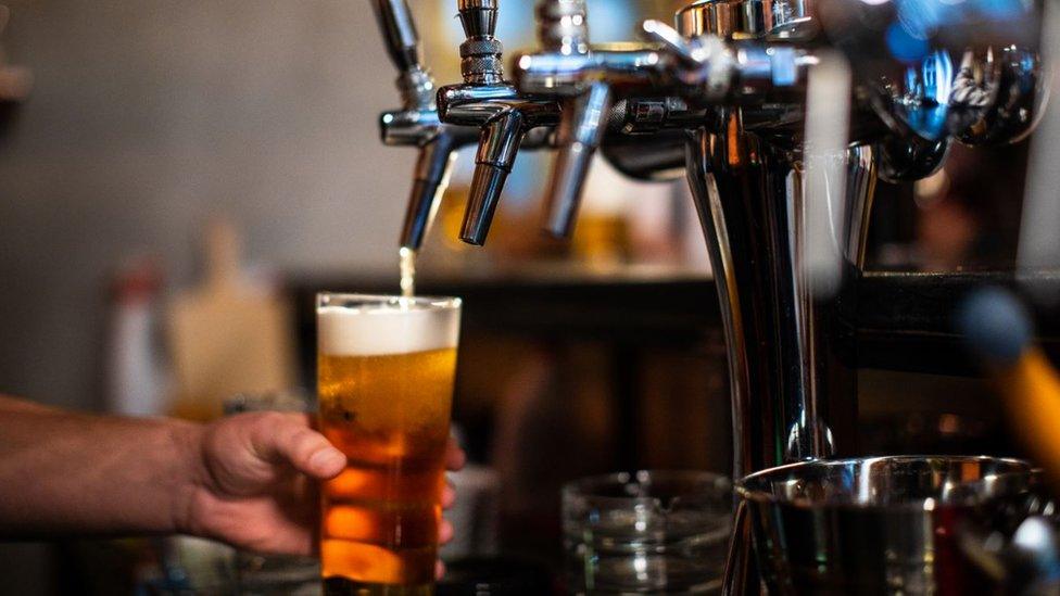 A drink being poured in the pub