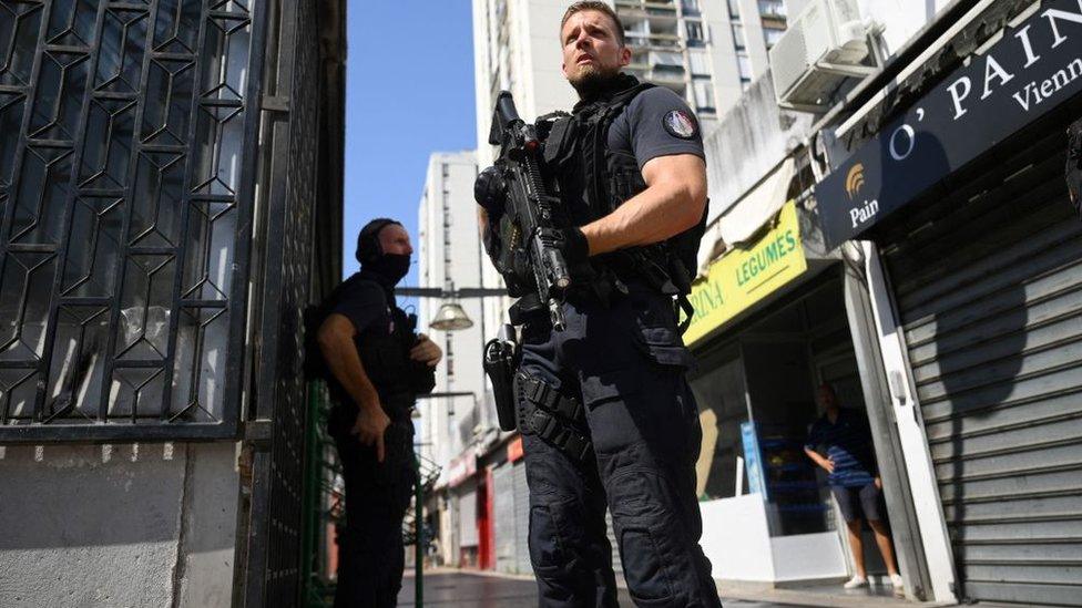 French police officers stand guard in Pissevin popular neighbourhood in Nimes, southern France on August 22, 2023, after a 10-year-old child died in a shootout