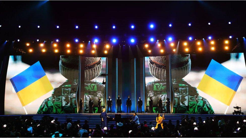 John Legend performs with Ukraine flags.