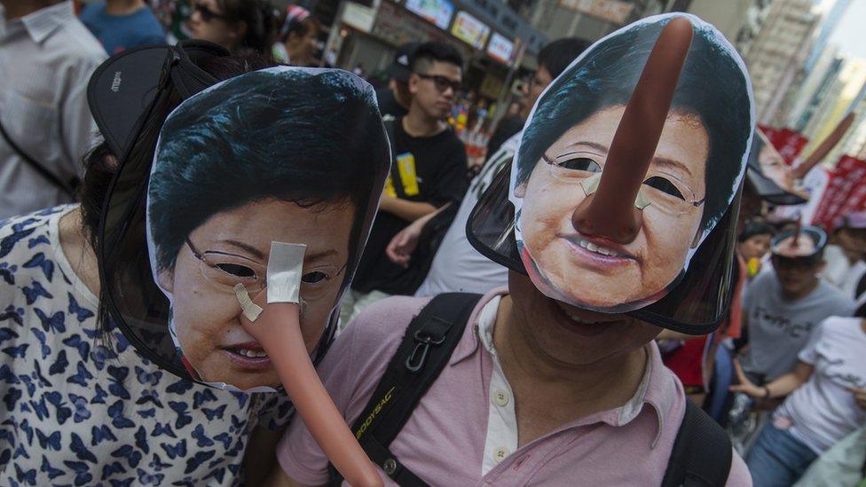 Protesters wearing masks of Hong Kong Chief Executive Carrie Lam, complete with a long "Pinocchio" noses to suggest lying, march through the streets during the annual pro-democracy march, Wan Chai, Hong Kong, China, 01 July 2018.