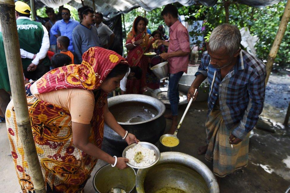 In this photograph taken on 21 September 2017 Hindu refugees from Myanmar cook a meal in a Hindu village near the Bangladeshi town of Kutupalong