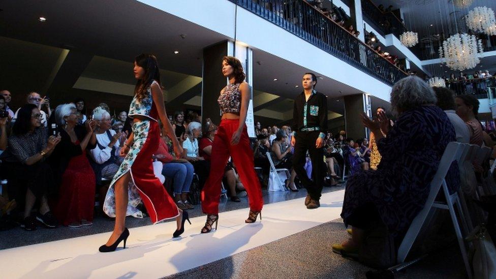 Spectators watch as models walk down the runway during the inaugural Vancouver Indigenous Fashion Week in Vancouver, British Columbia, Canada July 27, 2017.