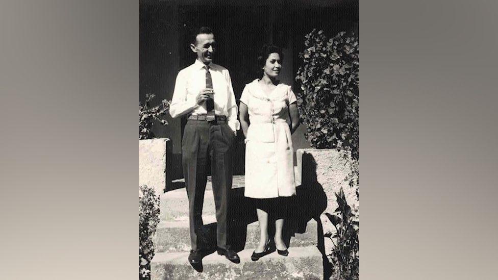 A man and a woman standing on some steps