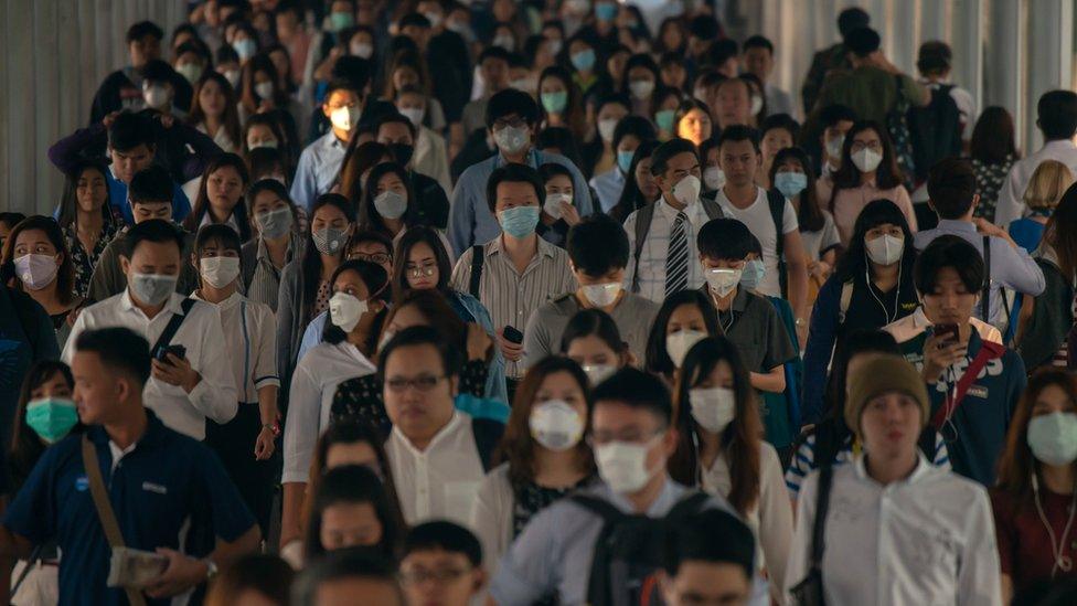 A crowd wearing surgical masks in China