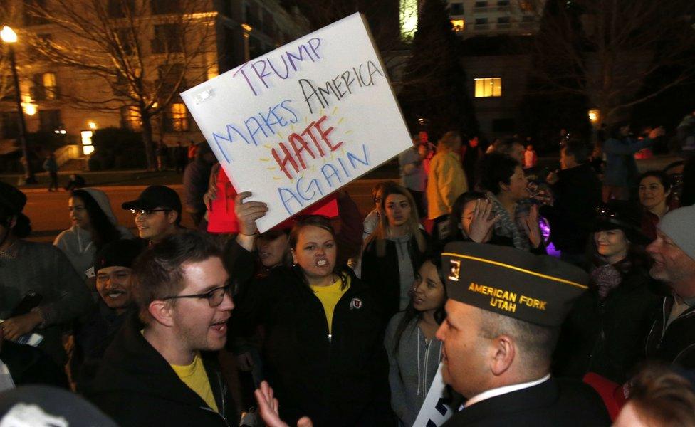 Anti-Trump protesters and pro-Trump supporters yell at each other outside the Infinity Event Center where Republican presidential candidate Donald Trump spoke at a campaign rally