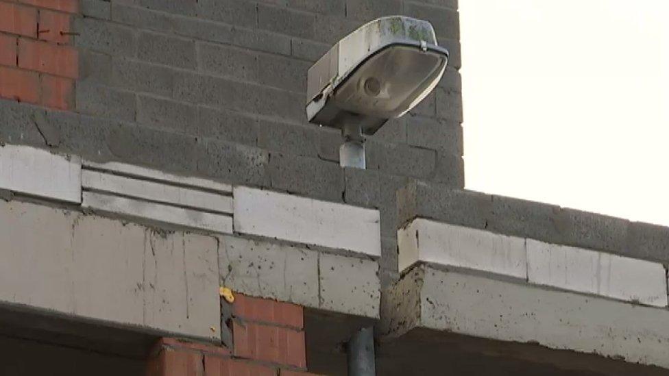 The street light enveloped by a building in Keerbergen