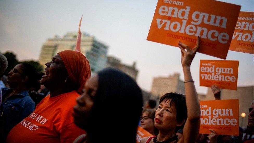 People hold a vigil to remember victims of the mass shootings at Dayton and El Paso, at Grand Army Plaza in Brooklyn, New York, August 5, 201