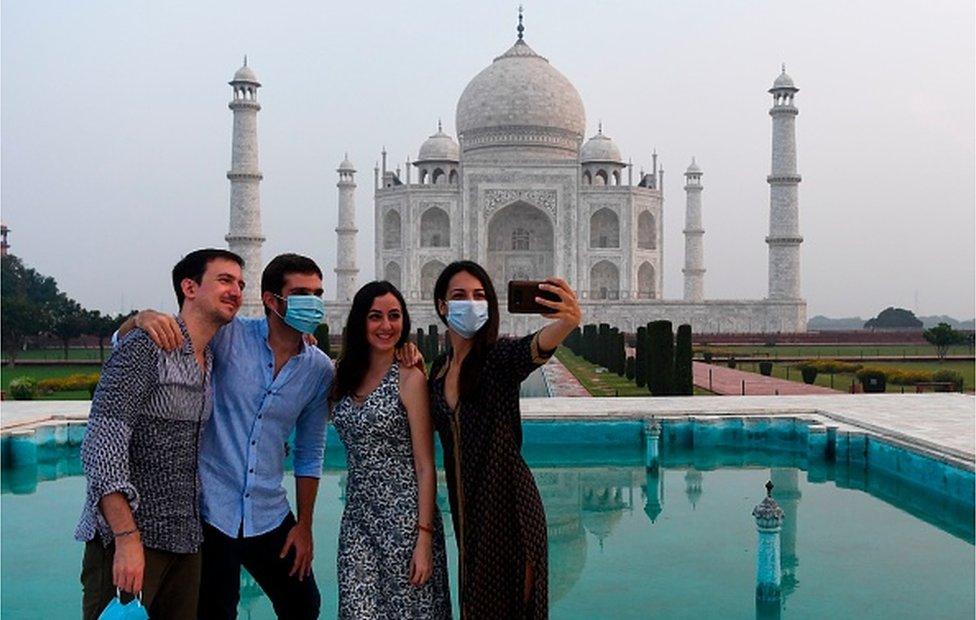 Tourists have their pictures taken at the Taj Mahal in Agra on September 21, 2020.