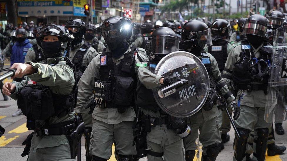 Riot police stand against demonstrators during a protest in the Wan Chai district of Hong Kong, China, on January 1, 2020.