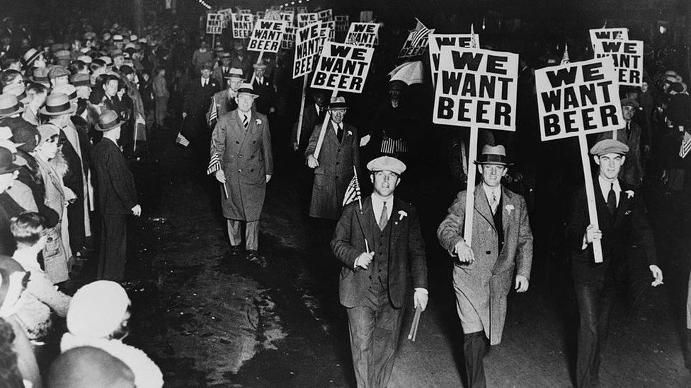 Men carrying placards reading "We want beer" in protests against US prohibition