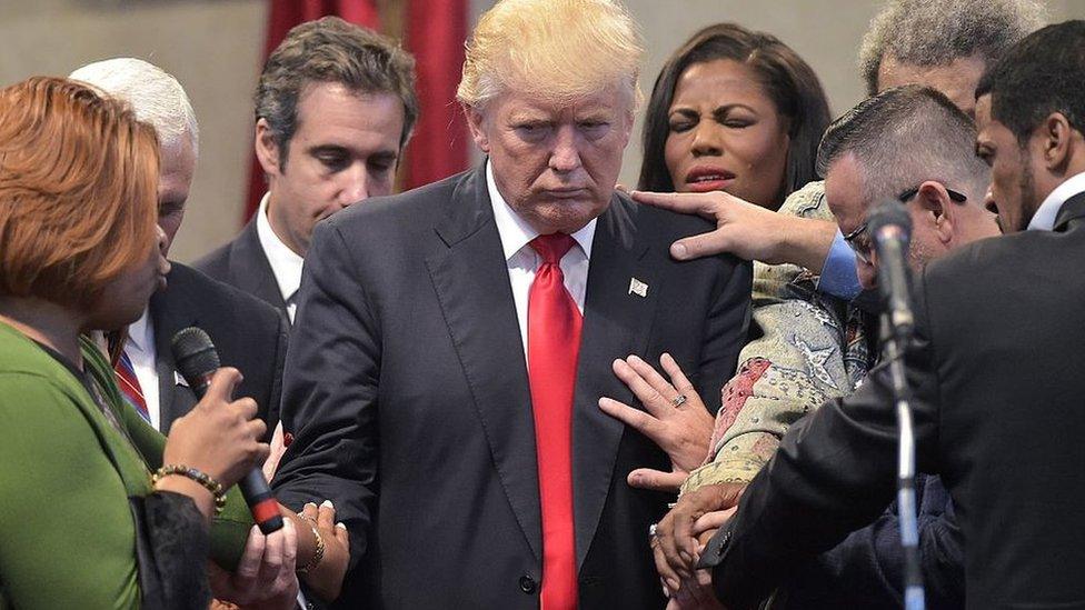 People pray for Trump during a visit to a revival church in Ohio