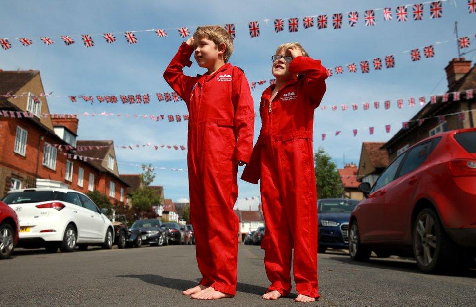 Max Panton, seven, and his five-year-old brother Theo joined the silence wearing their replica RAF Red Arrows uniforms