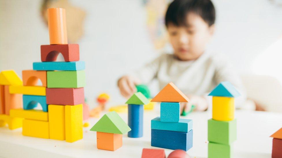 A boy playing with blocks