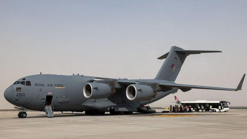 Afghans disembark a C-17 in the UAE