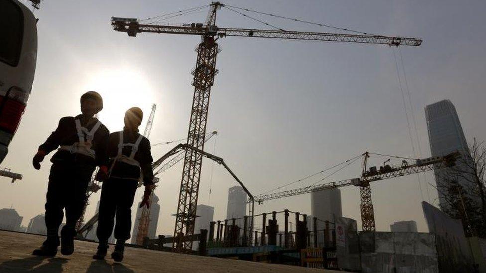 Workers at a construction site in Beijing