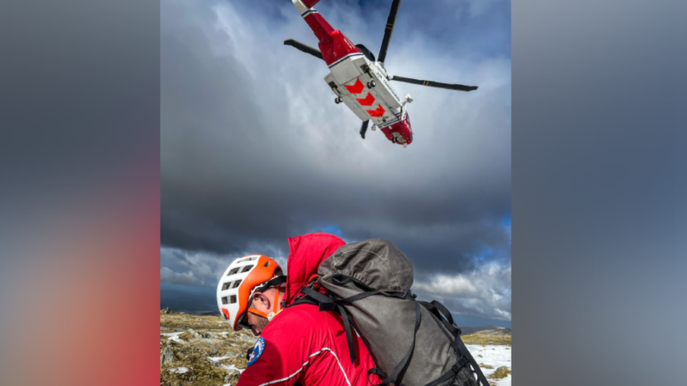 Llanberis Mountain Rescue Team member after being dropped off by Rescue 936 helicopter on the summit of Carnedd Ugain