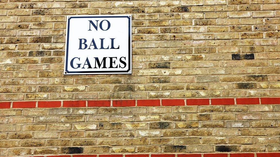 no-ball-games-sign-on-wall.