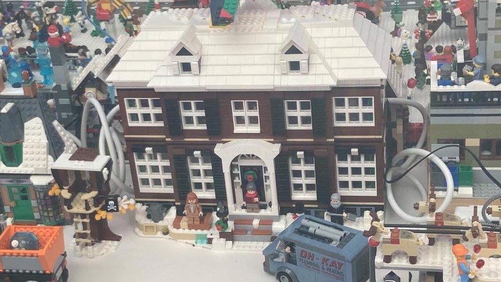 Brown two-storey house in Lego with pillars either side of the entrance door