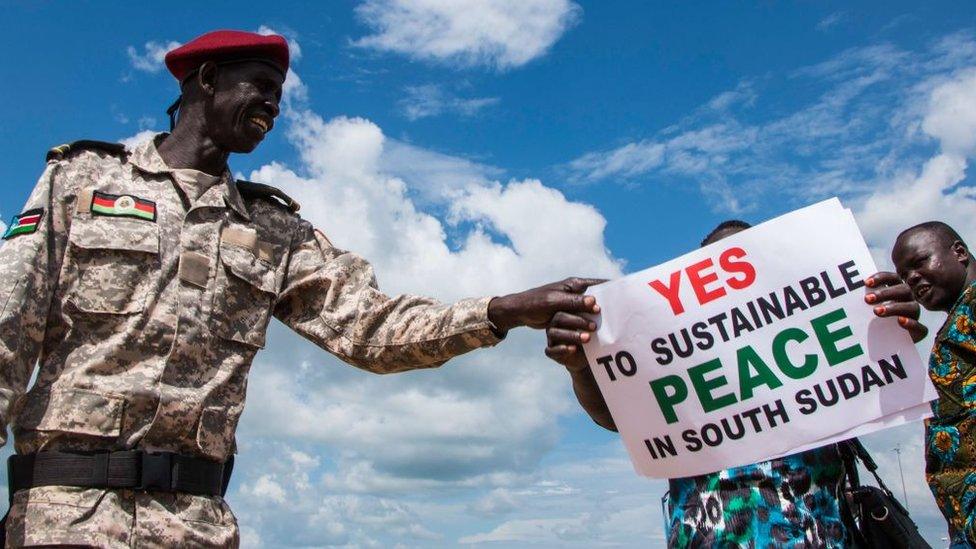 South Sudanese wait for the arrival of South Sudan's President at Juba International Airport in Juba on June 22, 2018