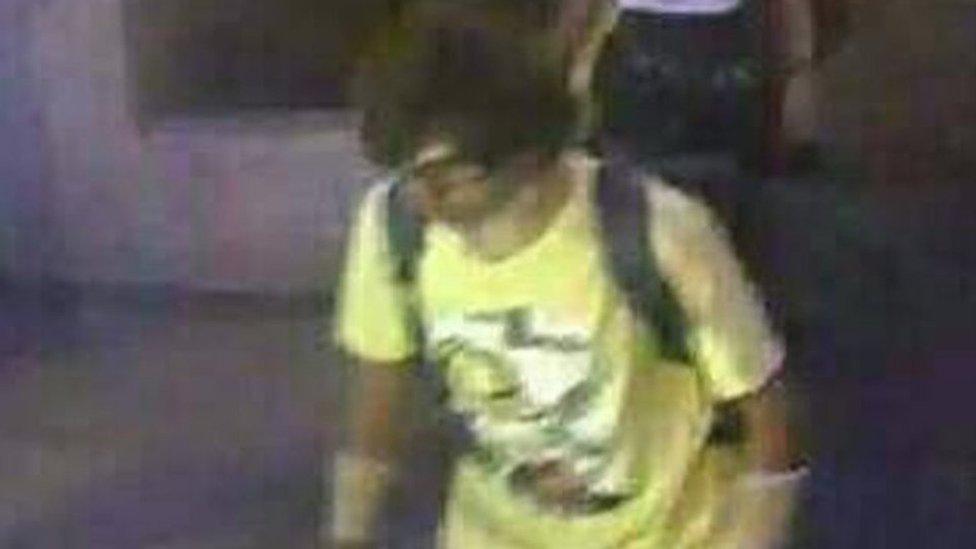 This Aug. 17, 2015, image, released by Royal Thai Police spokesman Lt. Gen. Prawut Thavornsiri shows a man wearing a yellow T-shirt near the Erawan Shrine before an explosion occurred in Bangkok, Thailand.