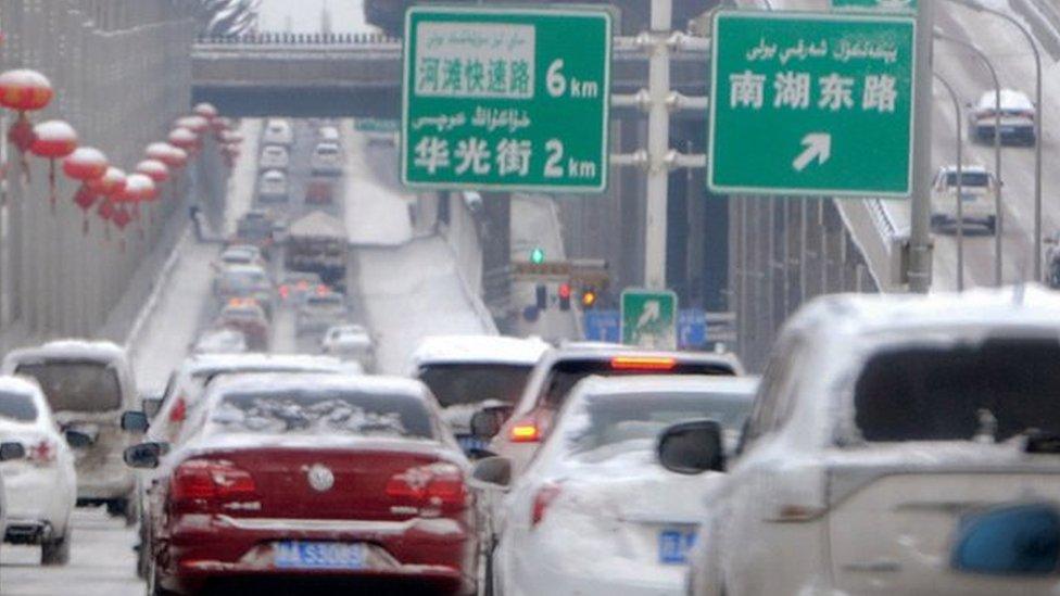 Vehicles on a snow-covered road in Urumqi, capital of China's Xinjiang region