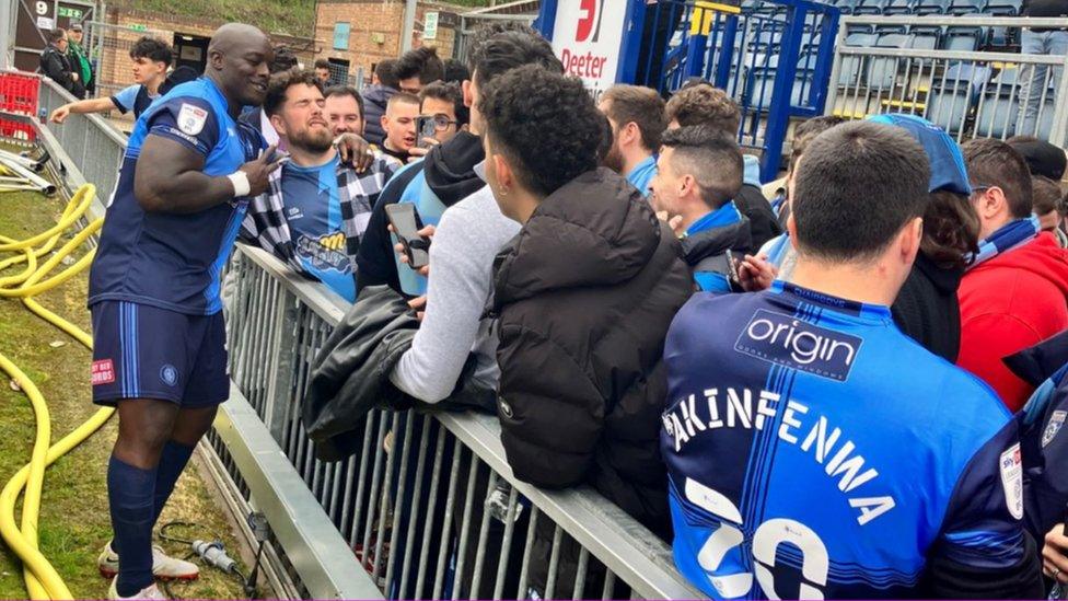 Wycombe fan with player Adebayo Akinfenwa