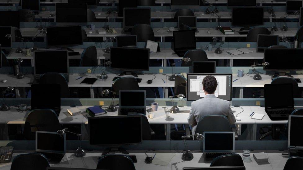 Man at workstation alone - stock image