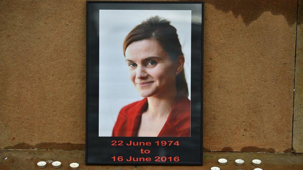 Candles surround a photo of Labour MP Jo Cox before a vigil in her memory