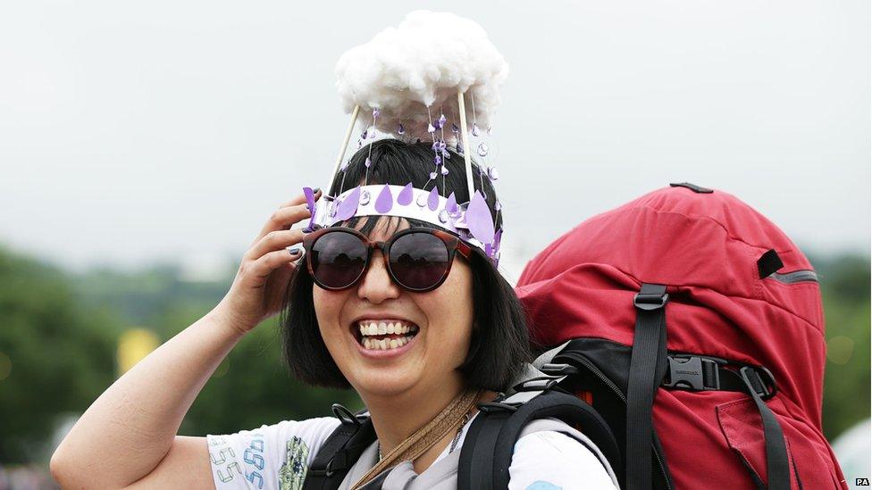 Woman wearing a hat made of a rain cloud
