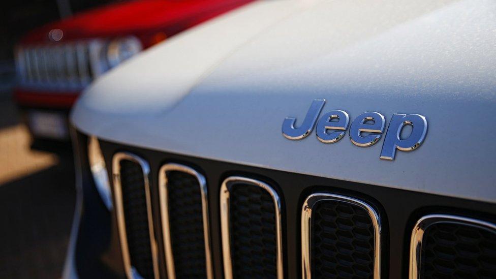 In this file photo taken on August 21, 2017 a car dealer in Turin shows the logos of Jeep, brands of Fiat Chrysler Automobiles (FCA).