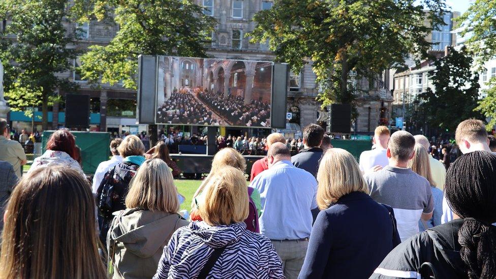 Crowds watching service at city hall