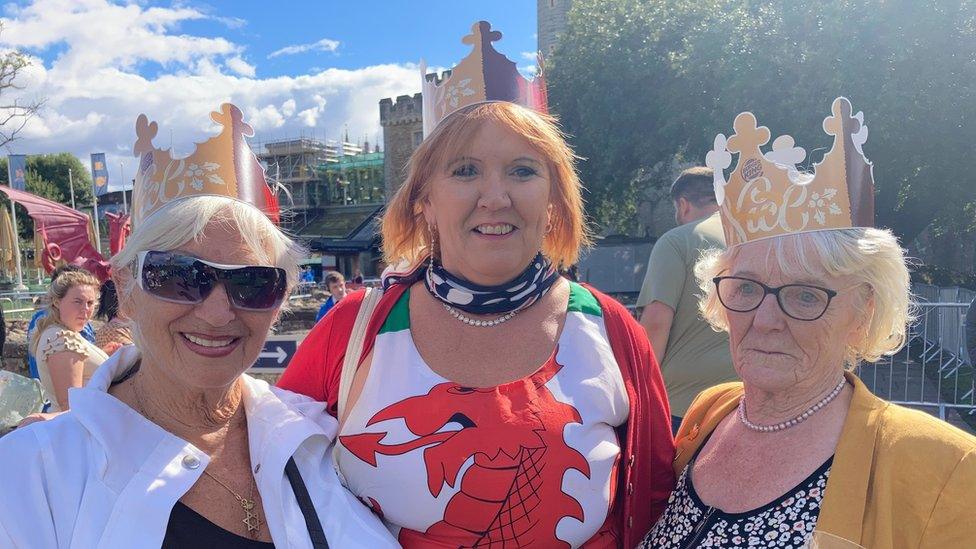 Three women wearing paper crowns