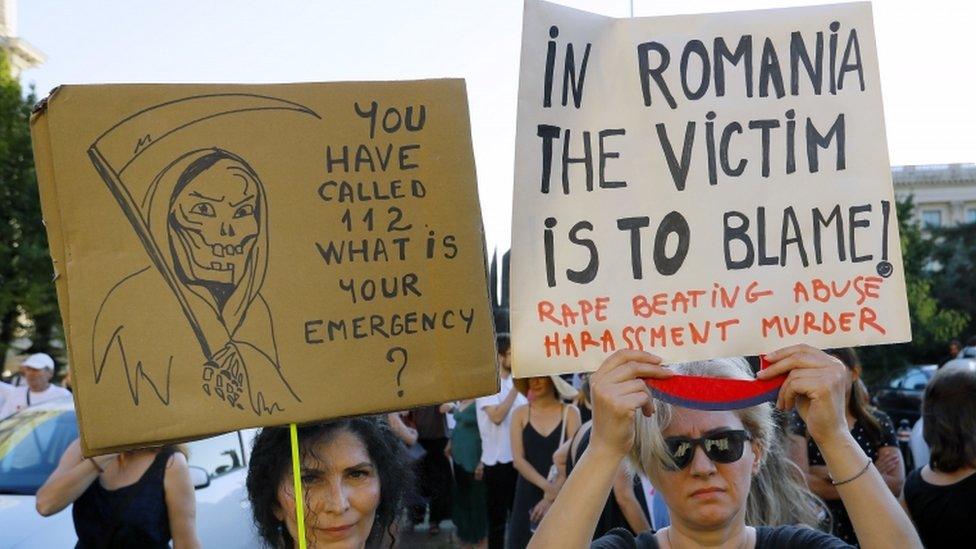 Protesters wave placards at a demonstration over the kidnapping of Alexandra Macesanu