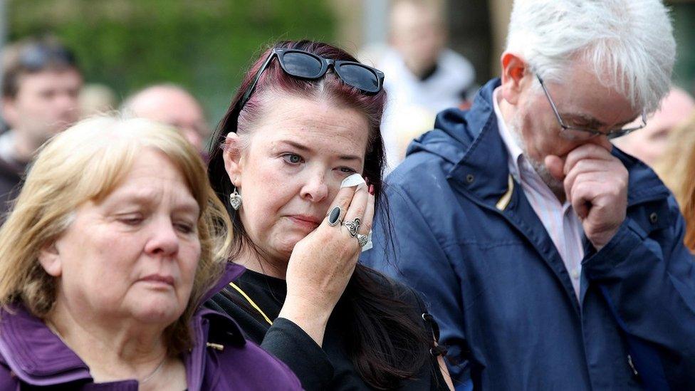 MEMBERS OF THE PUBLIC cry outside the funeral