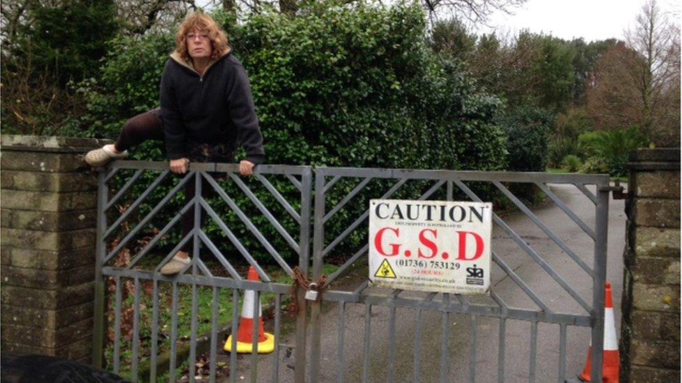 Martina Anscombe climbing cemetery gates
