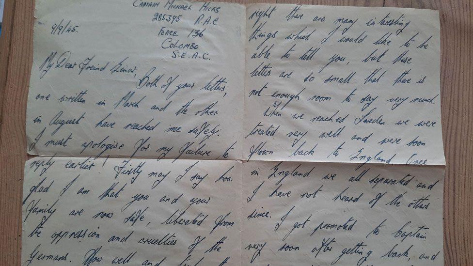 A letter written in blue ink on yellowing white paper dated 9/9/45. It is from Michael Hicks and he has written it from Colombo, present day Sri Lanka. The letter talks about how pleased he is to know Einar and family are safe and liberated and a little about his treatment in Sweden and flight home.