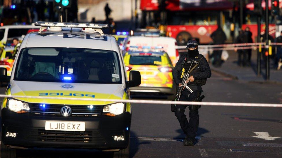 A Metropolitan Police Armed Response officer stands guard near Borough Market